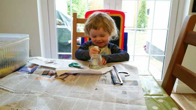 Small boy busy doing his own made-up art - and there's my new table cloth